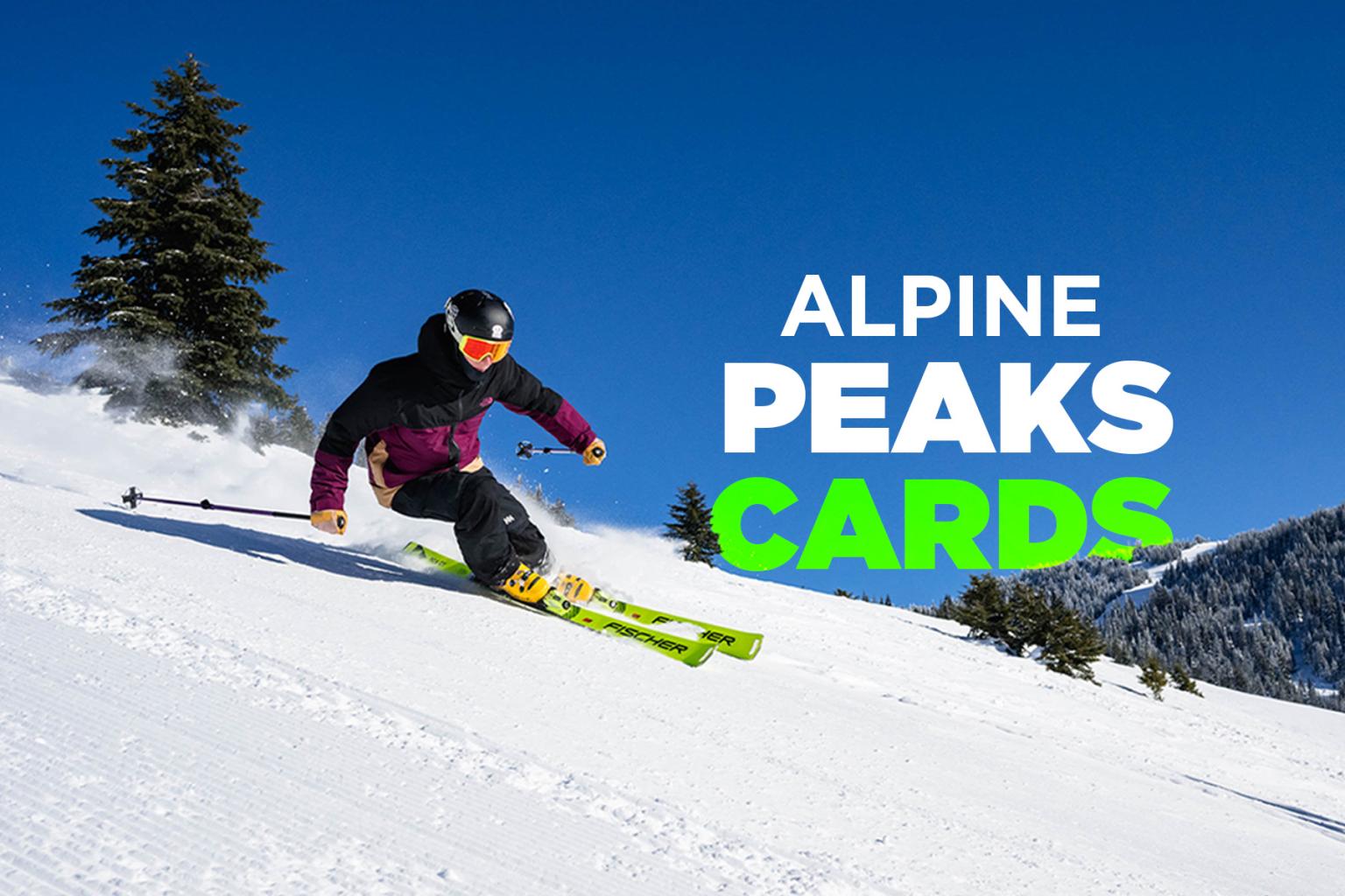 Skier in vibrant gear descending a snowy slope under a clear blue sky.