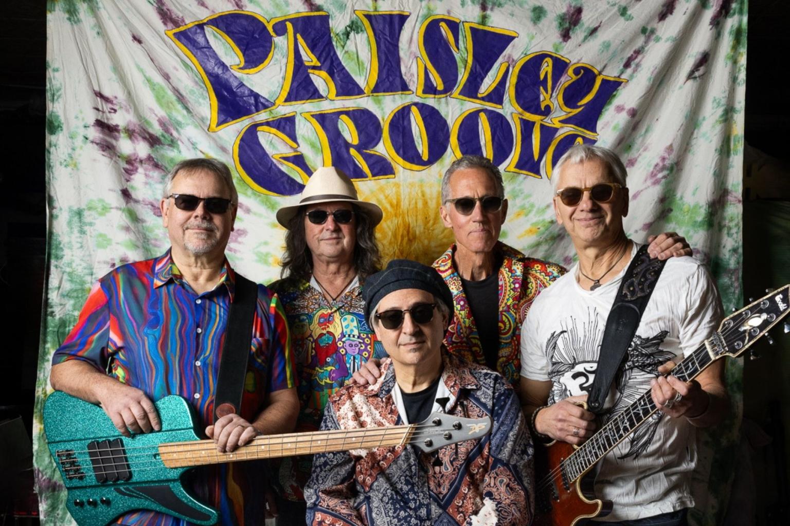 Band members with instruments in colorful shirts, standing together.