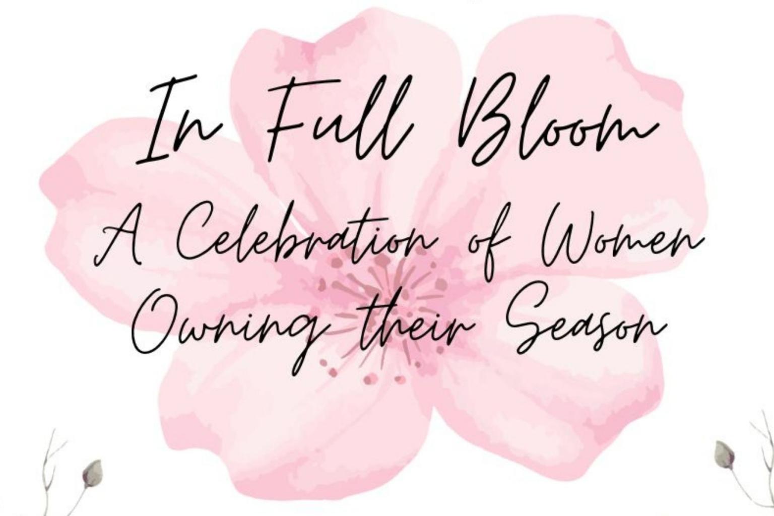 Pink watercolor flower with text overlay in script font. In Full Bloom. A Celebration of Women Owning Their Season.