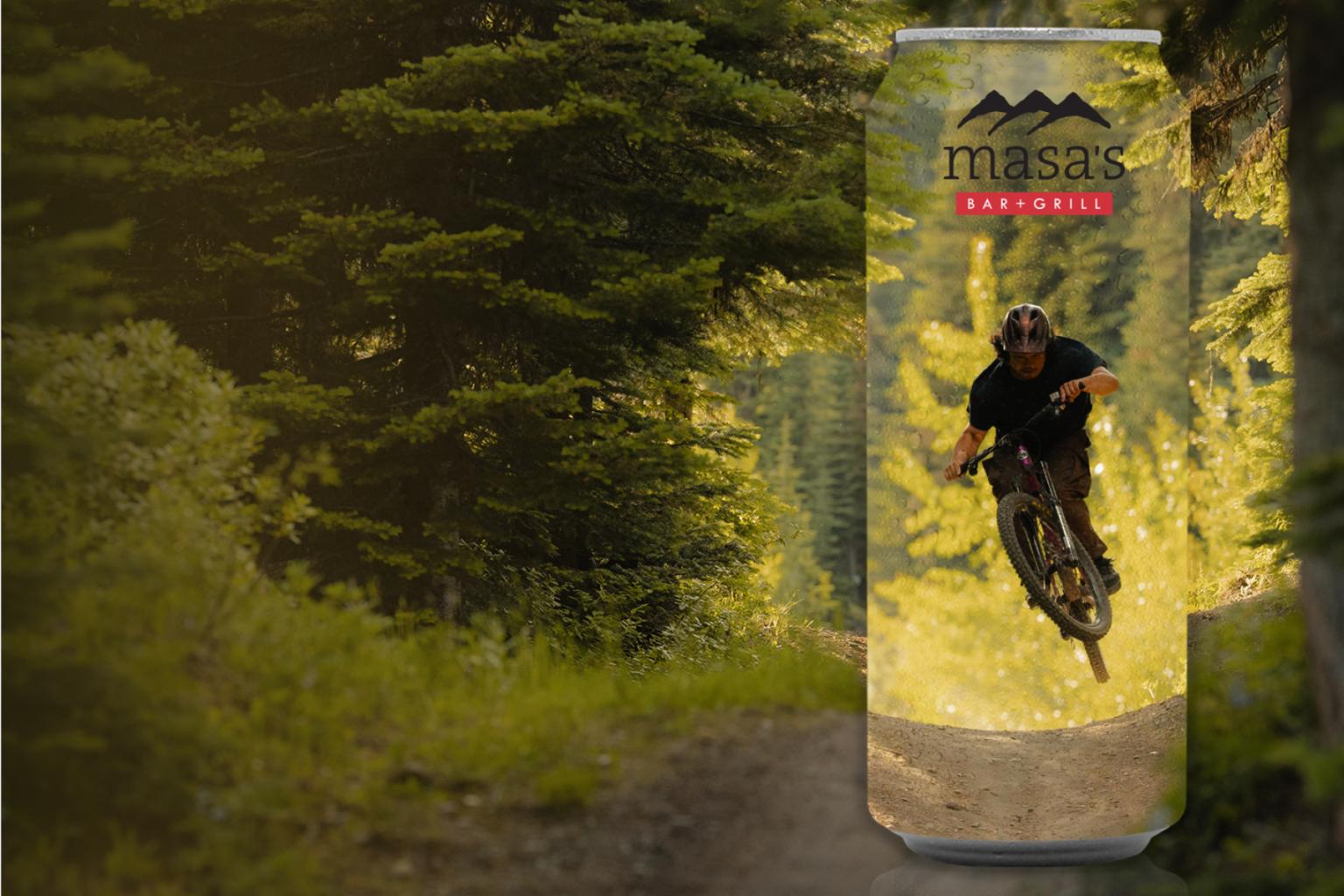 Mountain biker jumping in a forest, shown on a tall beverage can with forest background.