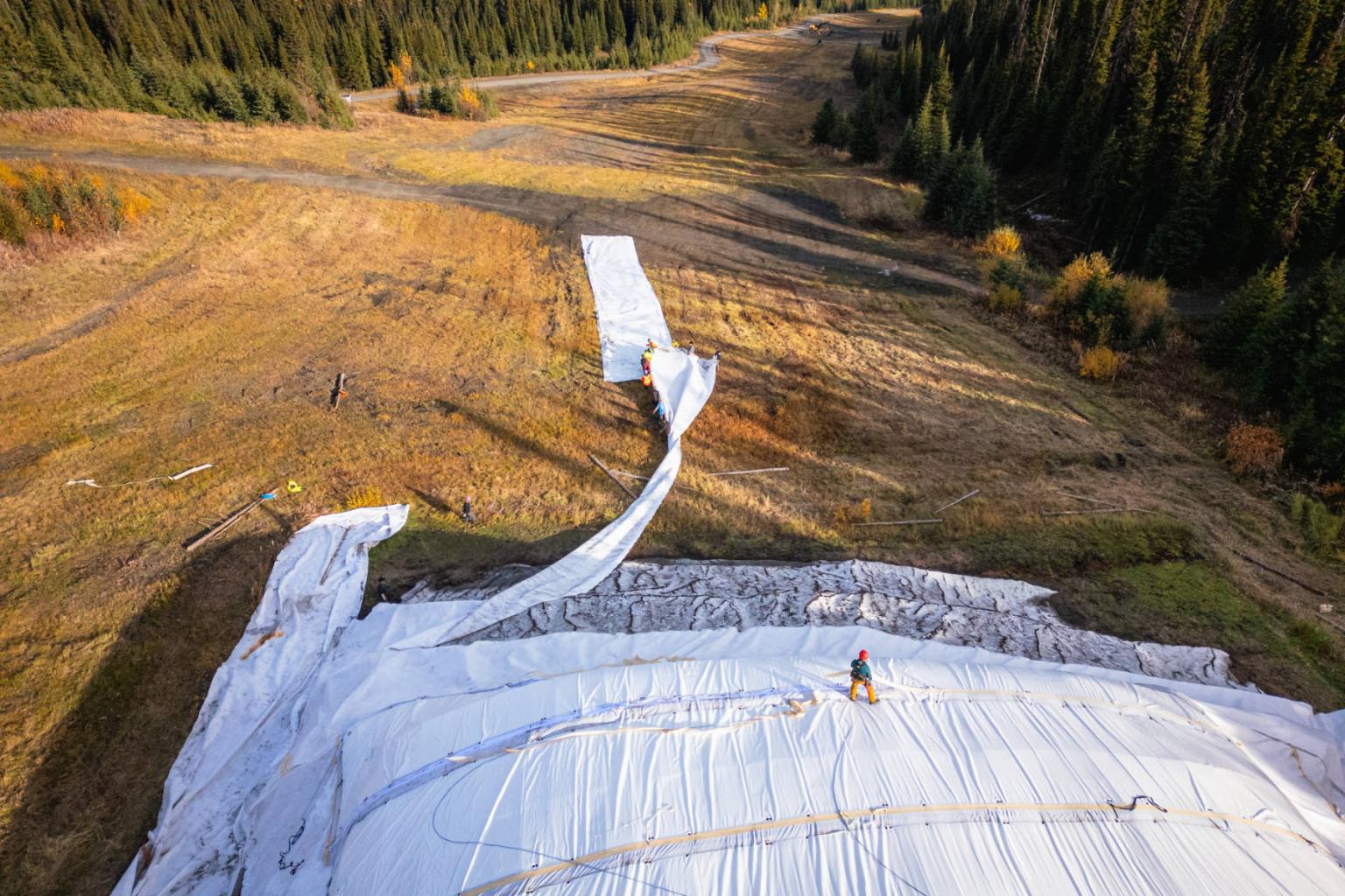 Aerial view of Sun Peaks team removing insulated mats.
