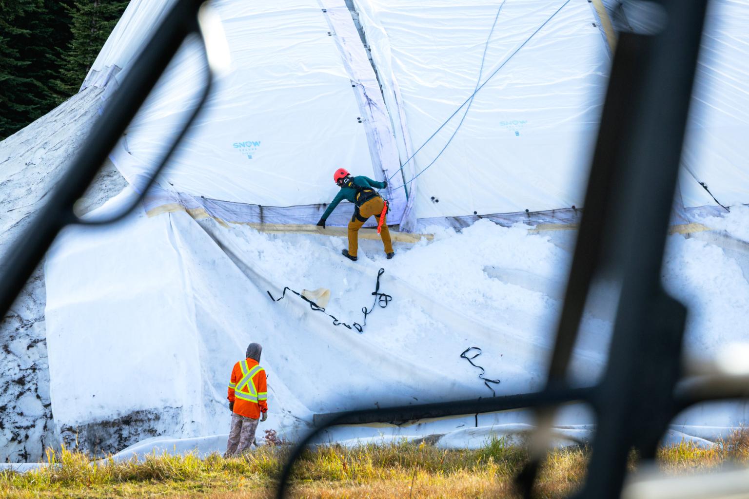 Aerial view of Sun Peaks team removing insulated mats.