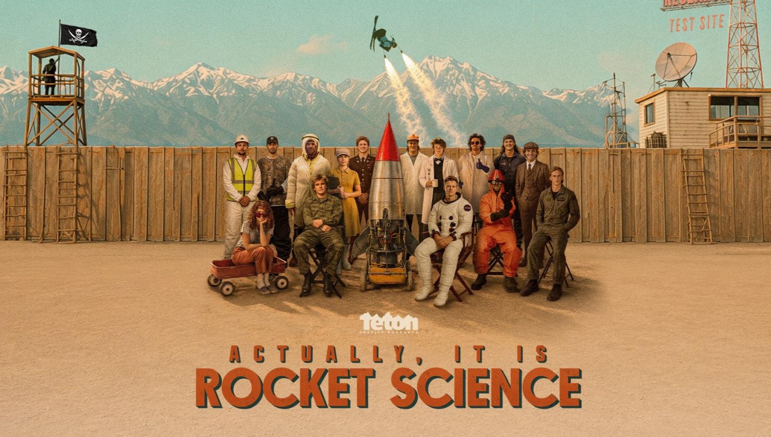 A group stood around a rocket in a Wild West style desert scene, with a skier taking off through the air in the background. Text reads "Actually, It Is Rocket Science".