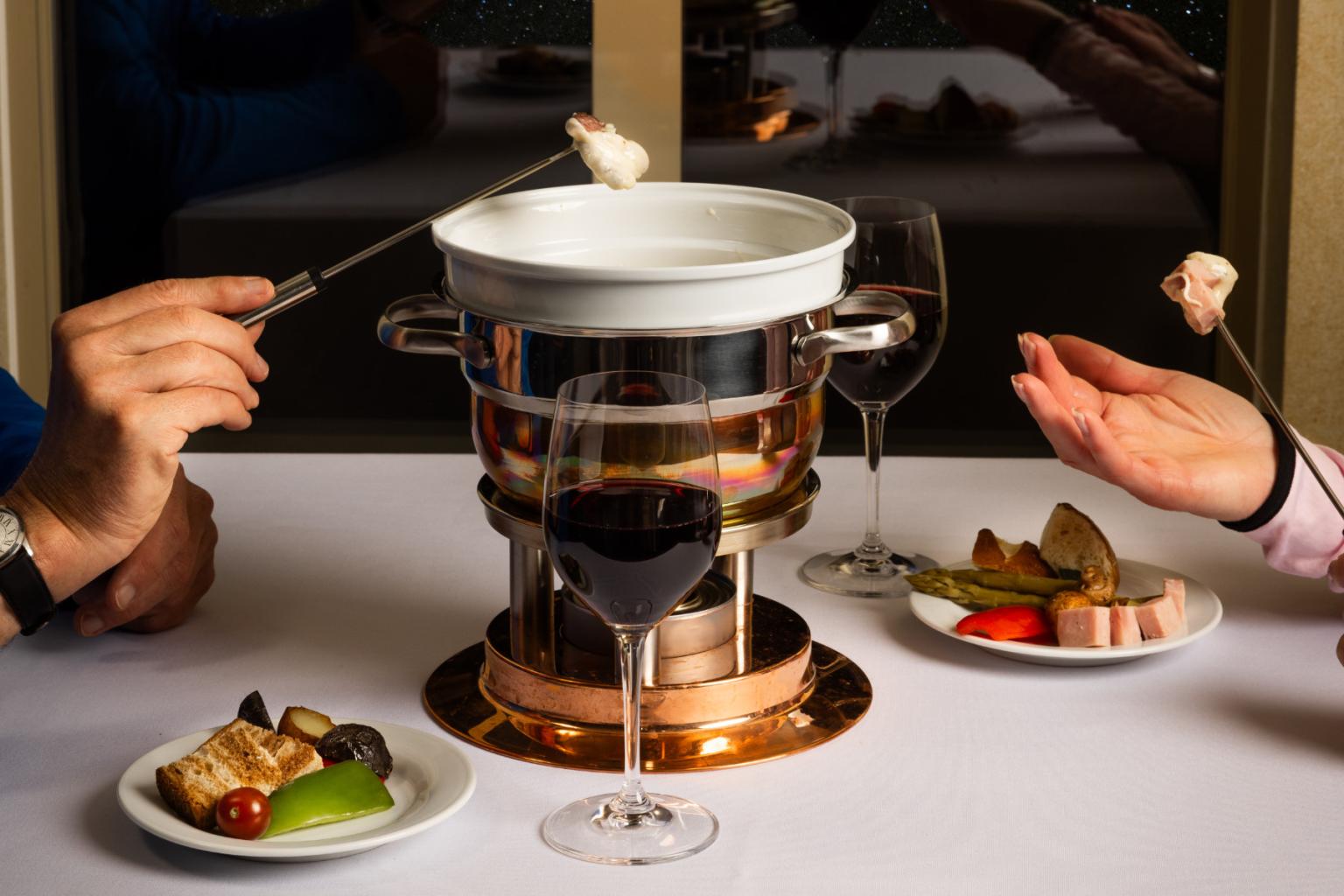 Fondue pot with people dipping