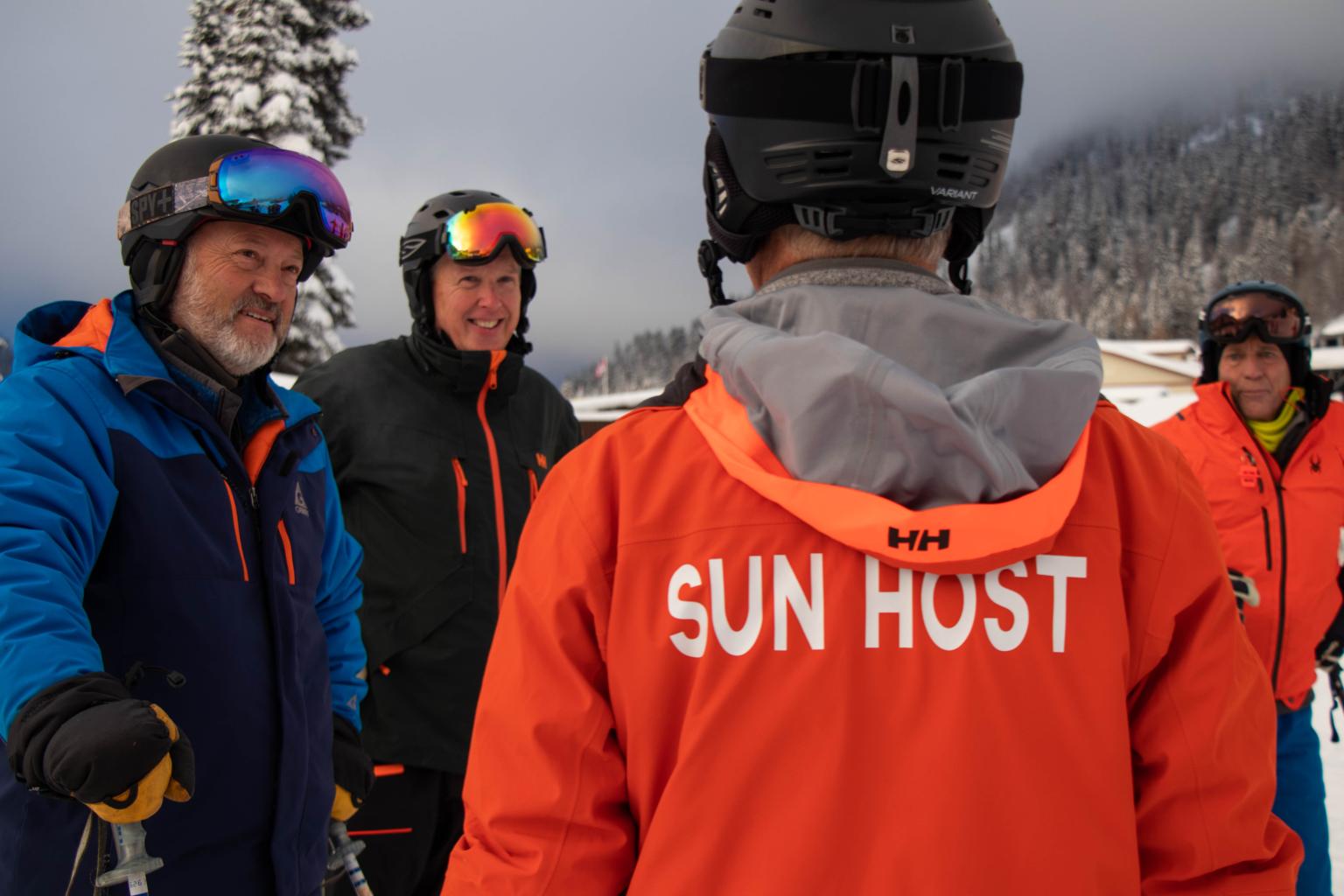Sun Host speaking to fellow skiers