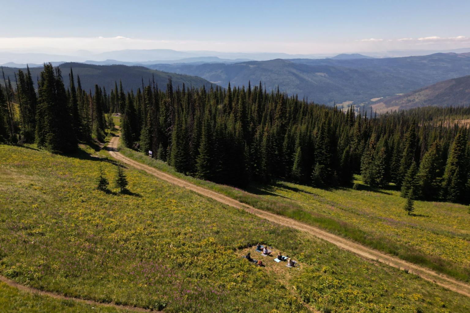 A group of people practicing yoga with mountain views