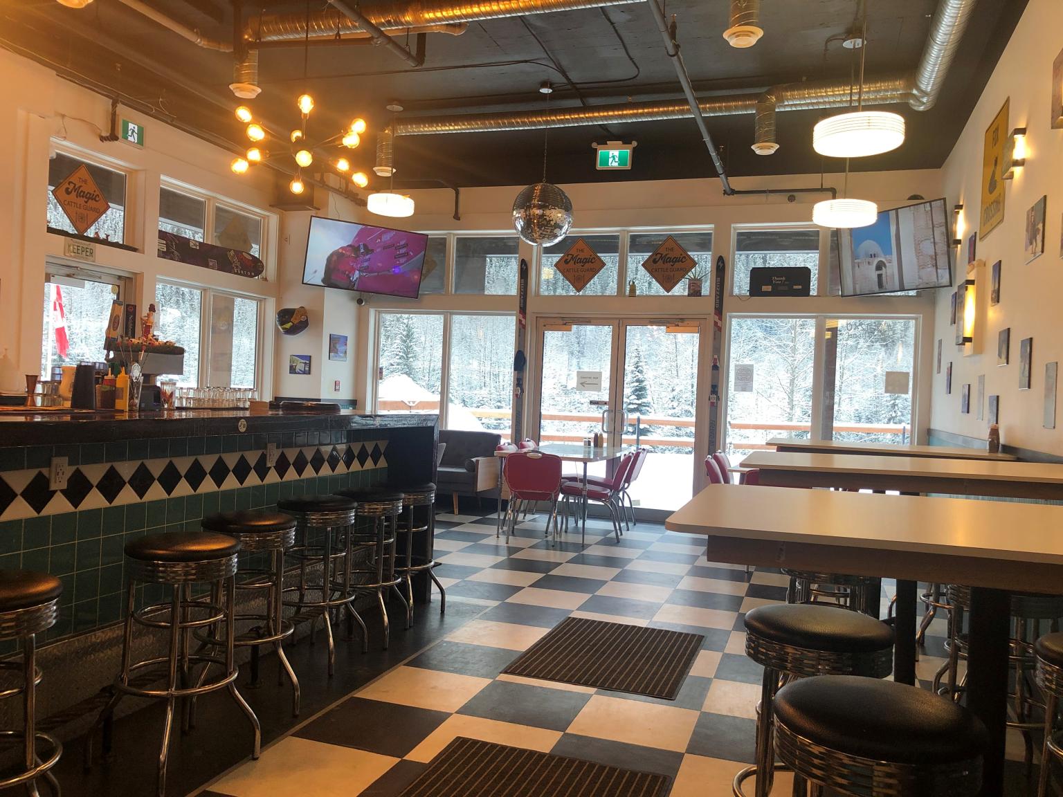 dining tables and a bar inside a restraunt