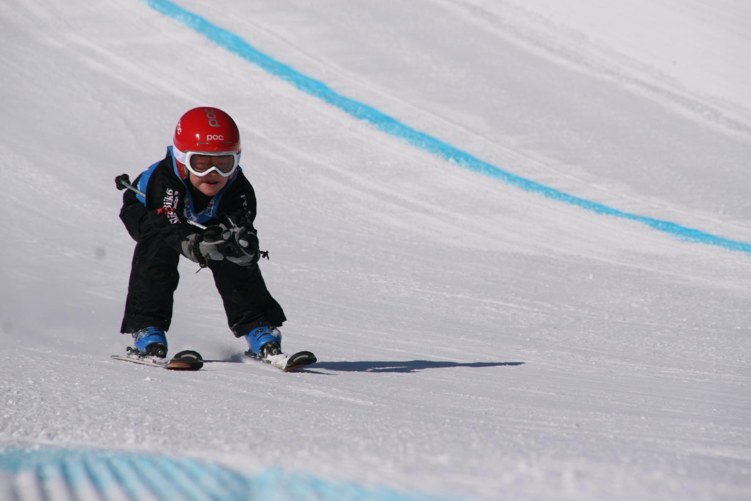A Skier skiing down the slopes on a track