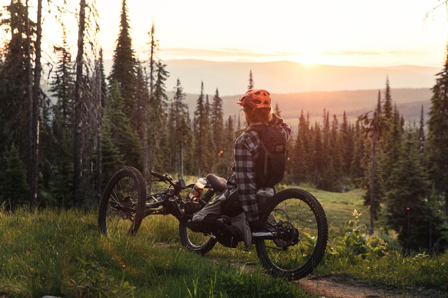 Adaptive mountain biker with the sunset