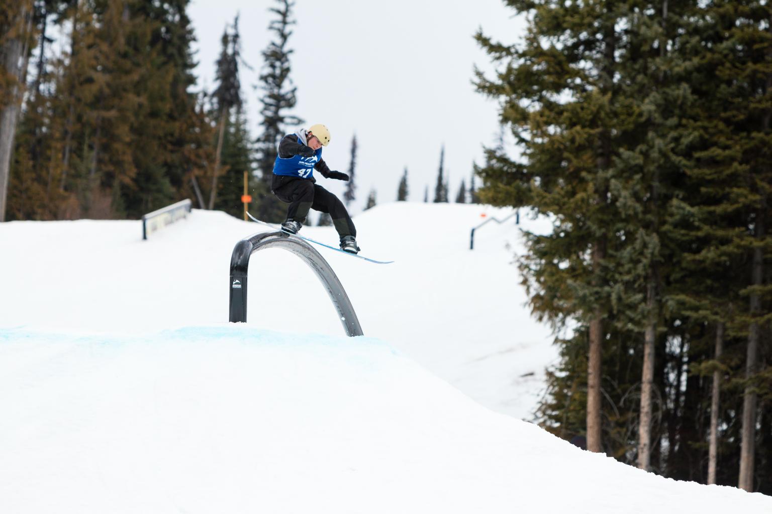 snowboarder sliding rail