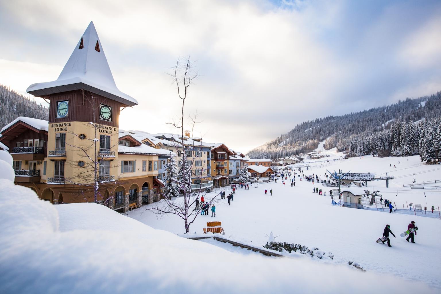Sun Peaks village in winter with clocktower and snow