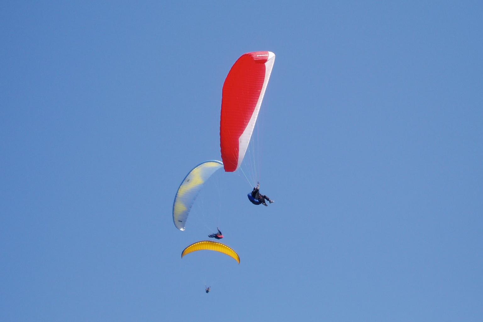 Three paragliders in the sky