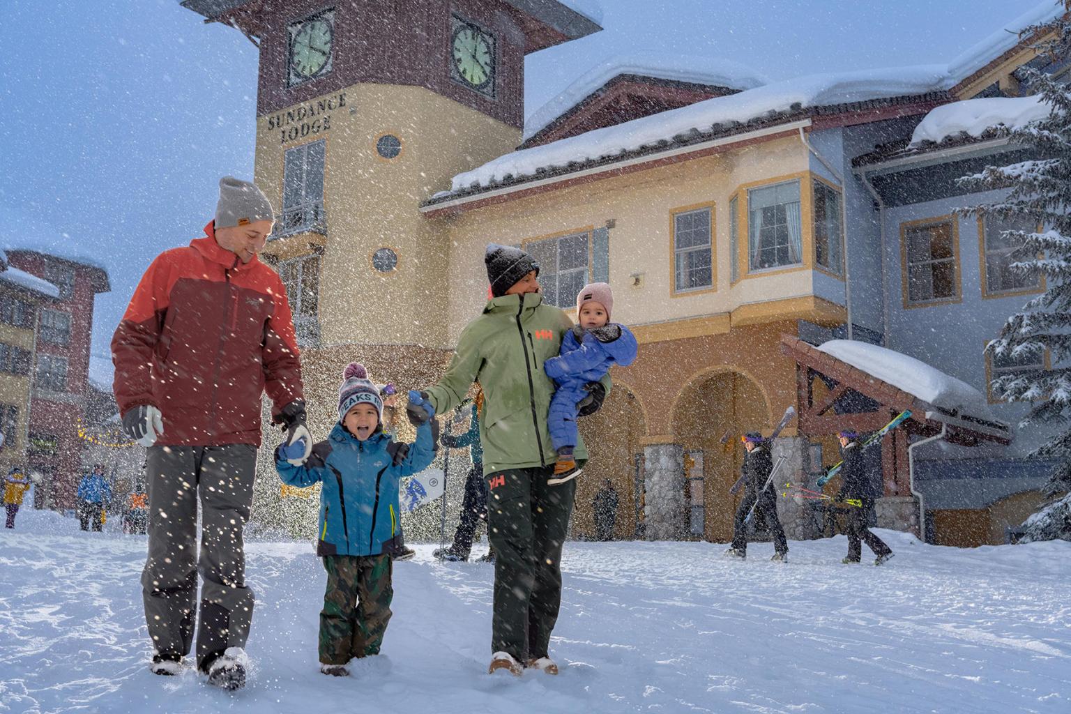 Family holding hands walking in the snow