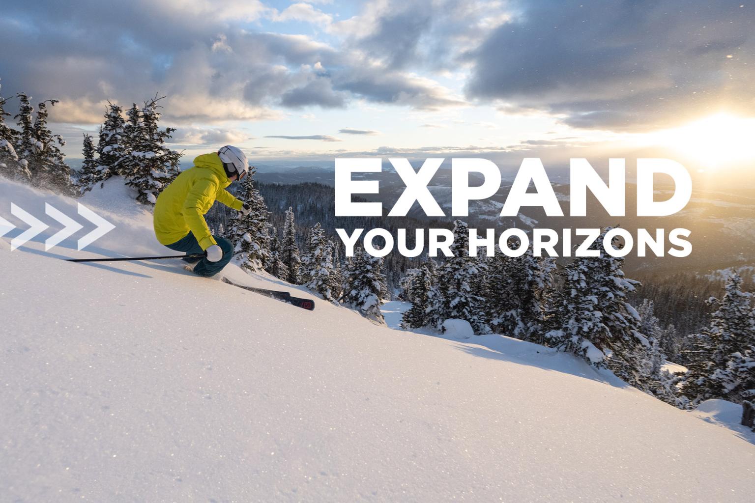 Skier in pow with sun rise