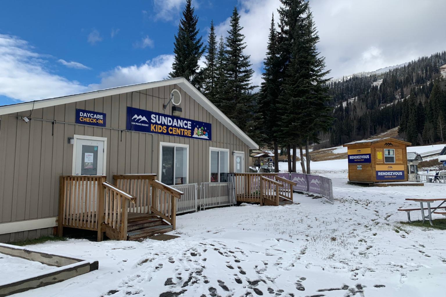 outside view of a building with trees and snow around it